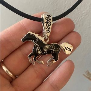 Horse pendant on black necklace